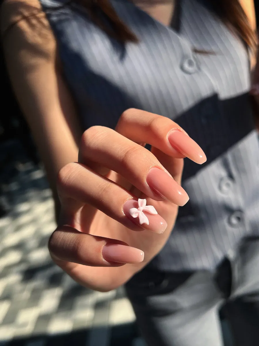 Nude manicure with a 3D bow