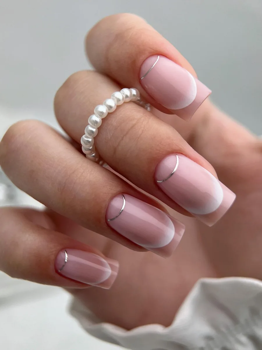 Soft pink manicure with a white gradient and a silver line
